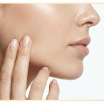 person touching jaw masseter area for tmj exercise and tension relief