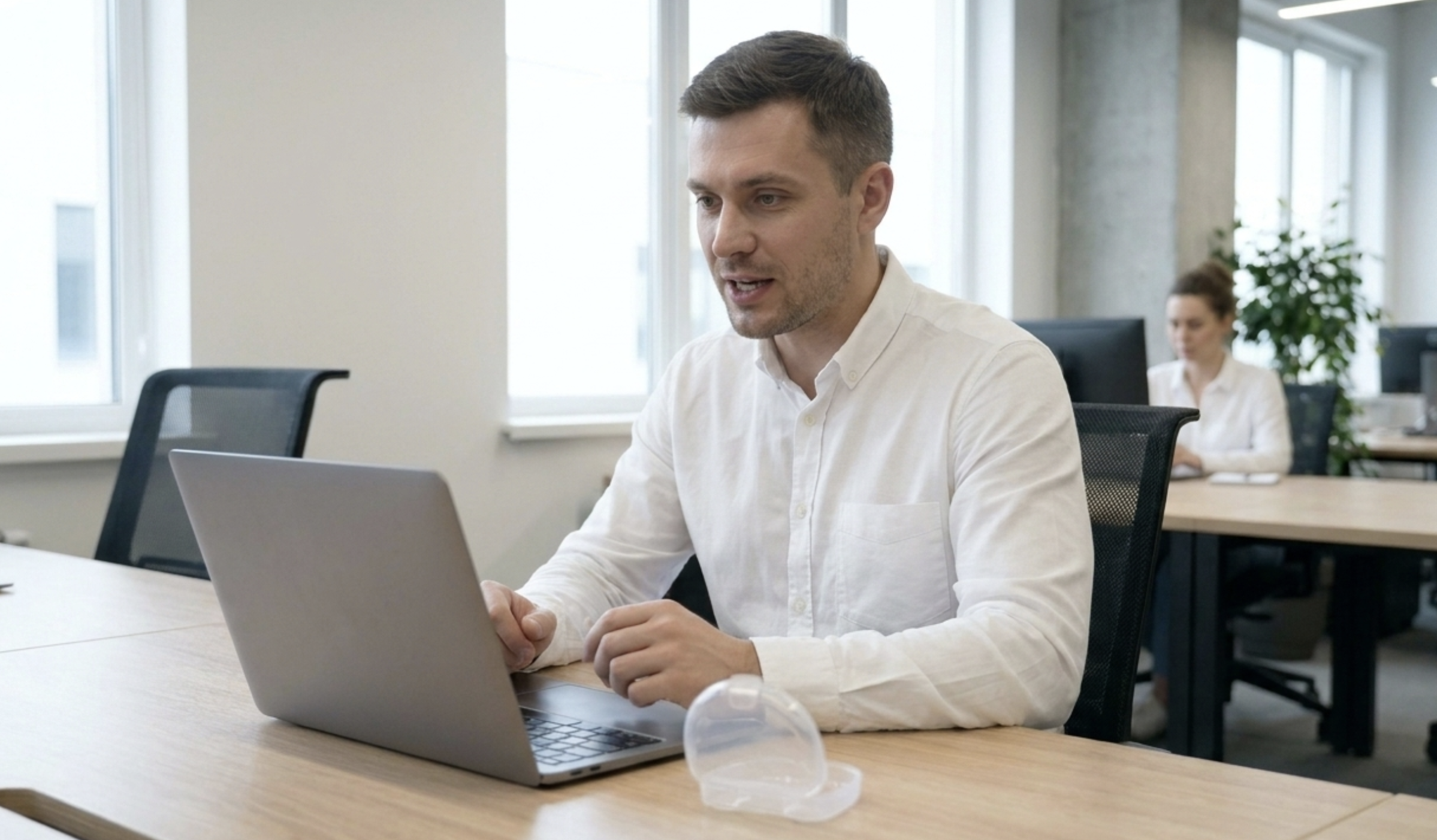 person wearing ultra-thin daytime guard during work meeting